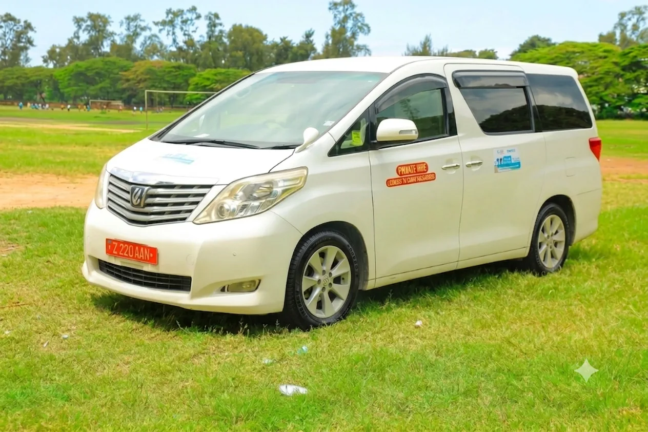 White Toyota Alphard minivan parked on the lawn ready for private hire