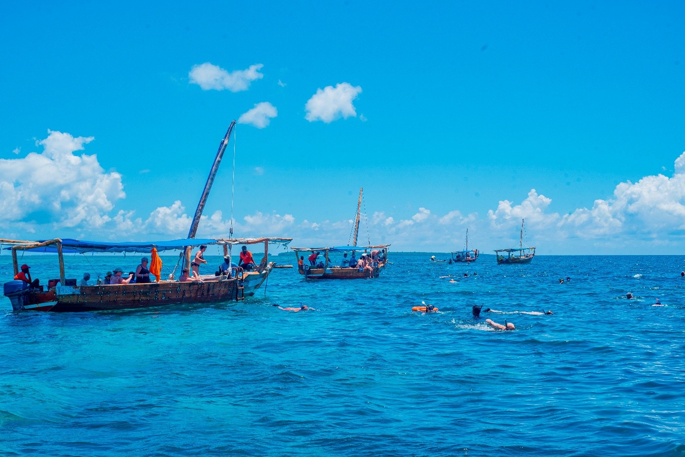 Swimming near traditional dhow boats on the Safari Blue excursion