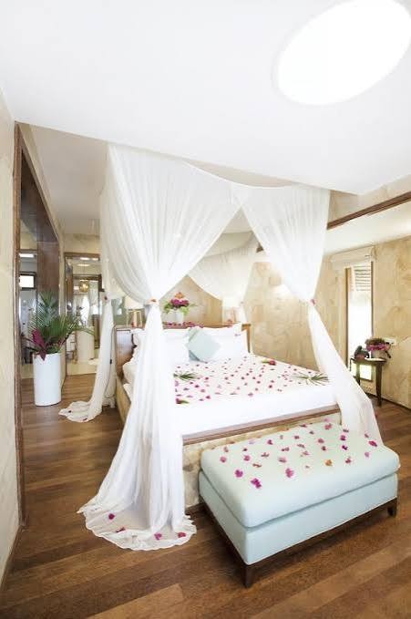 Tulia bedroom with canopy bed decorated with flower petals