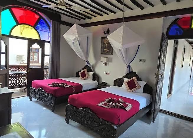 Dhow Palace room with two beds and mosquito nets