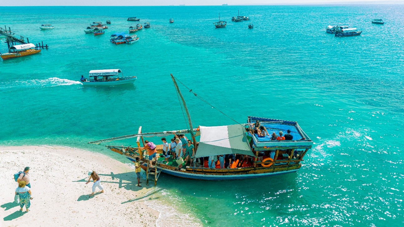 A boat in turquoise water at Nakupenda Sandbank