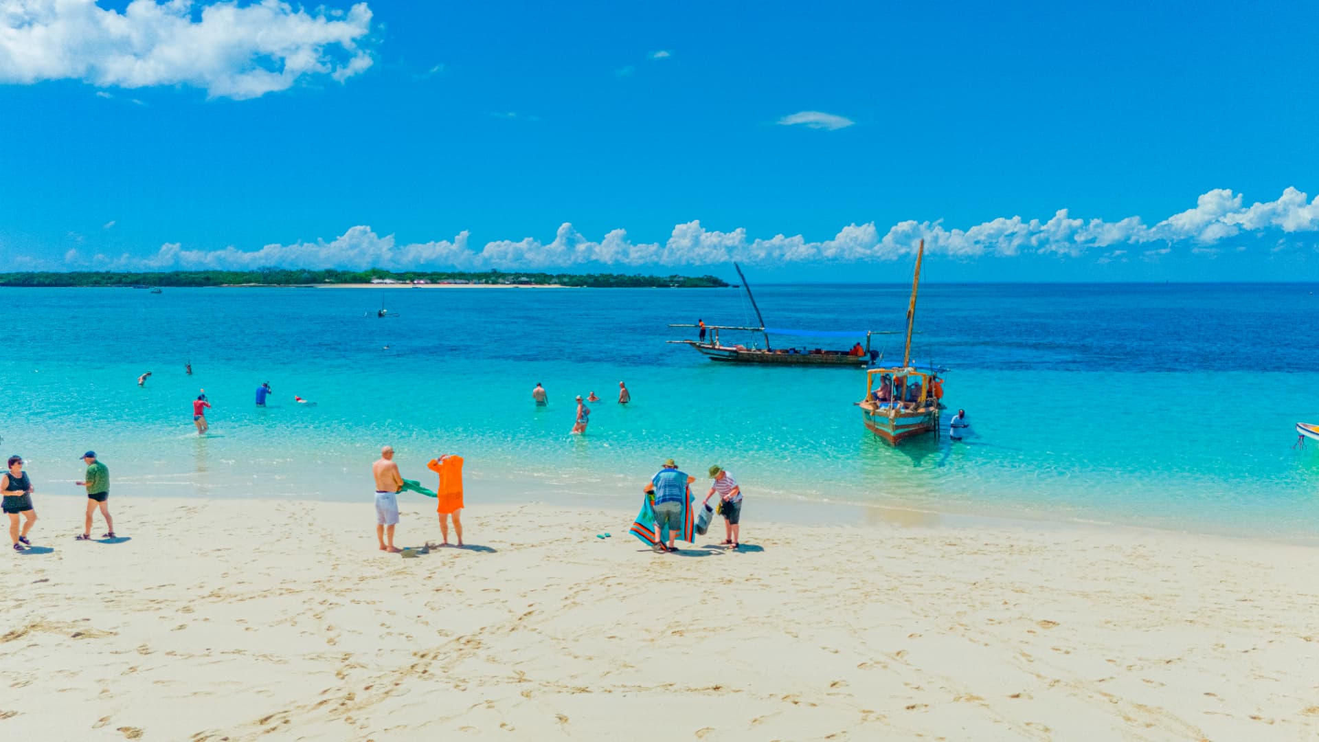 White sand beach with dhows and turquoise water in Zanzibar