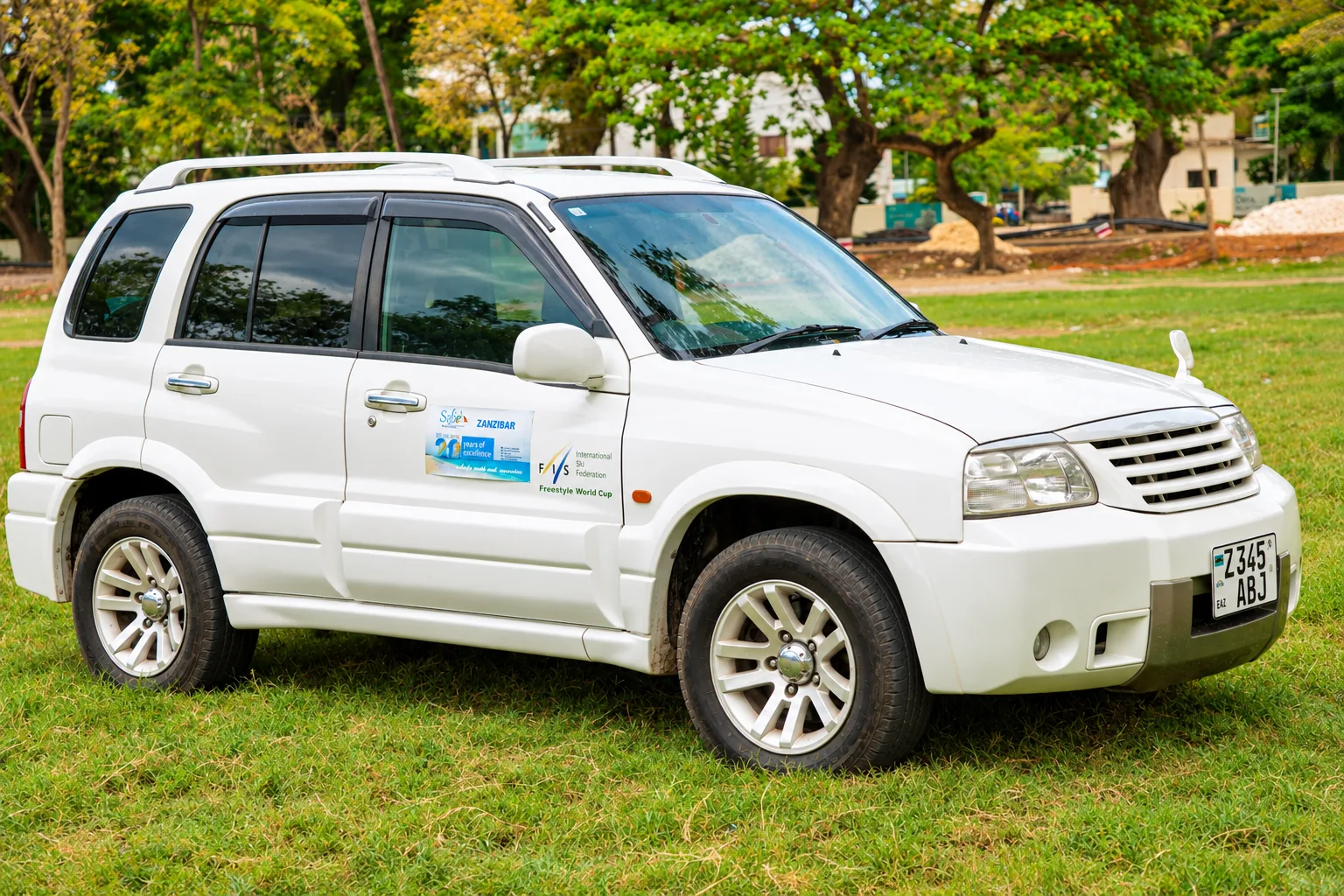 White Suzuki Escudo SUV parked on the lawn ready for private hire